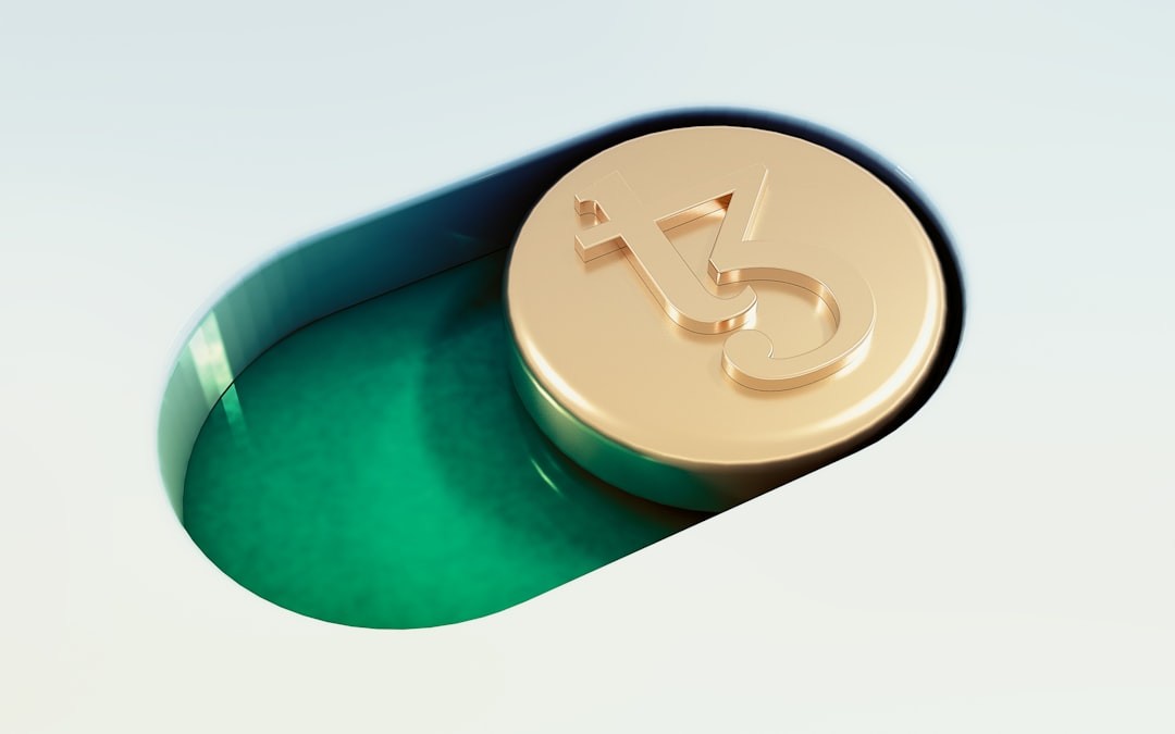 Close-up shot of a Tezos Cryptocurrency coin, stylized as a toggle notification button.